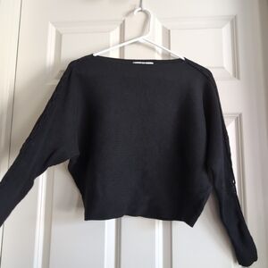 Black horizontal ribbed batwing sweater with criss cross lacing up the sleeves